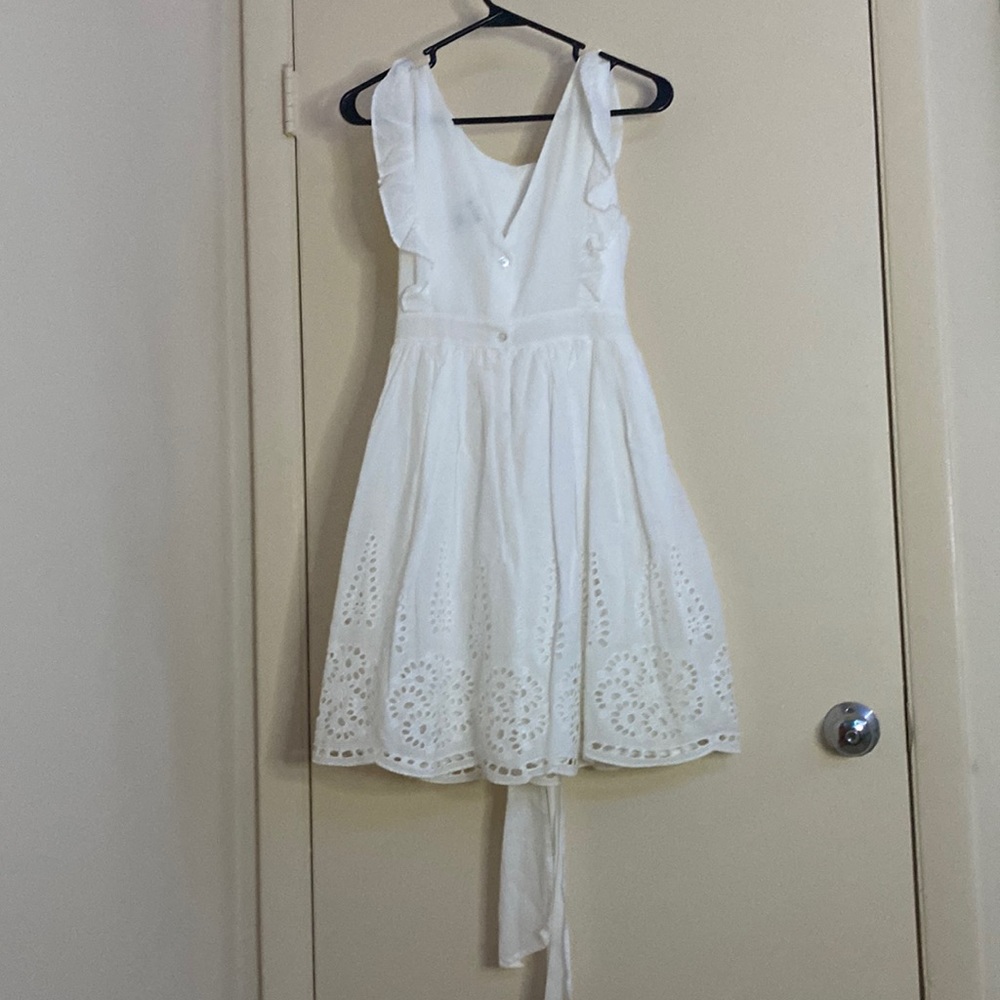 All white dress with belt and design/ details at the bottom